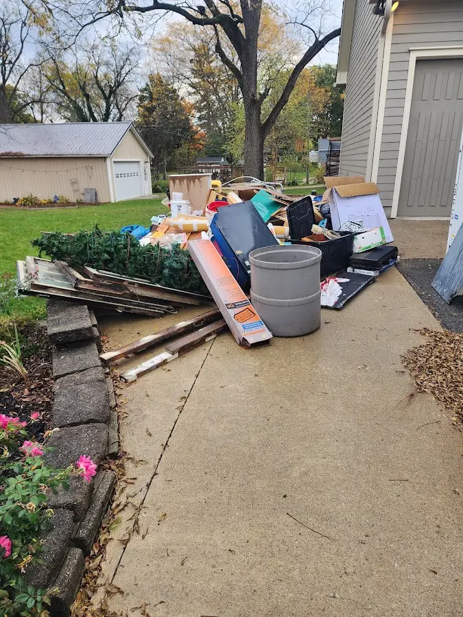 Dumpster being loaded with debris for 12 Yard Dumpster Rental in Oroville